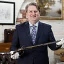 Bloomfield Auctions Managing Director Karl Bennett with a sword pistol linked to the 1689 Siege of Derry