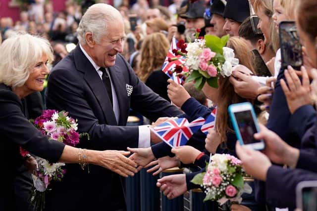 Britain's King Charles III and Britain's Camilla, Queen Consort greet wellwishers as they arrive at Hillsborough Castle in Belfast on September 13, 2022, during his visit to Northern Ireland