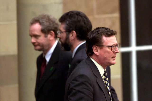 First Minister David Trimble (right) walks past Sinn Fein leader Gerry Adams during talks at Hillsborough, near Belfast.