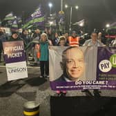 Unison members with banners targeting Secretary of State for Northern Ireland Chris Heaton-Harris during an earlier strike