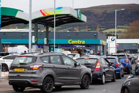 Northern Ireland  drivers queue for cheap fuel as Black Friday deals begin across garages. Motorists were queued outside the Centra Stewartstown Road forecourt on Wednesday morning