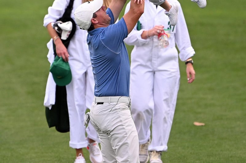 AUGUSTA, GEORGIA - APRIL 05: Rory McIlroy of Northern Ireland  celebrates with his daughter Poppy McIlroy on the first hole during the Par 3 contest prior to the 2023 Masters Tournament at Augusta National Golf Club on April 05, 2023 in Augusta, Georgia. (Photo by Ross Kinnaird/Getty Images)