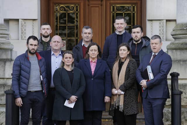 Children of murdered GAA official Sean Brown, Siobhan Brown (centre), Sean Brown (second from right) Clare Loughran (4th left), with family, friends and solicitor Niall Murphy (right) on the steps of the Royal Courts of Justice in Belfast. Picture date: Thursday November 23, 2023.