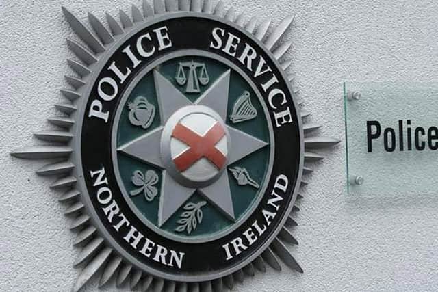 The officers were kicked, bitten and spat on, the PSNI said.