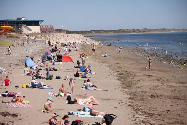 Members of the public at Newcastle beach, County Down as temperatures rise across Northern Ireland during a spell of warm summer weather. Photo by Kelvin Boyes / Press Eye.