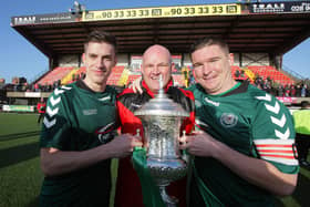 Stephen Gourley celebrates captaining Dundela to Steel & Sons Cup success in 2013 alongside Mark Snodden and Andrew Ferguson. PIC: Matt Mackey/Presseye