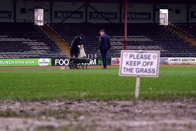Ground staff worked on the pitch ahead of the cinch Premiership match between Dundee and Rangers at Dens Park before officials called the game off