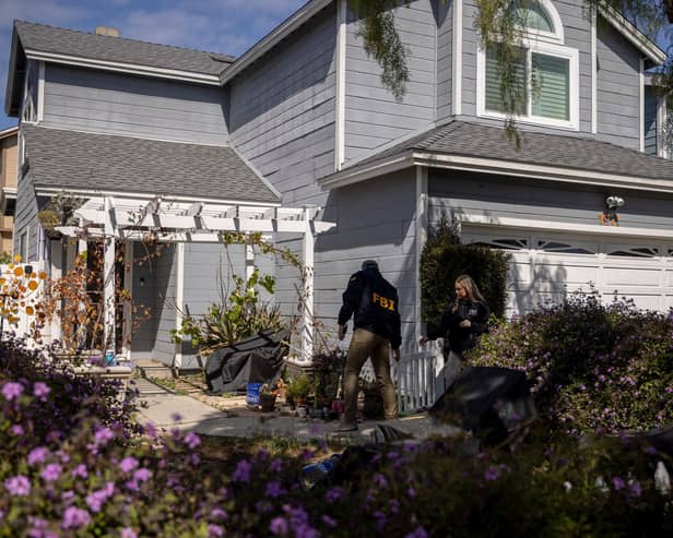 FBI agents at a home in a nice California neighbourhood beside one linked to Trump gun suspect. (Stephen Lam/San Francisco Chronicle via AP)