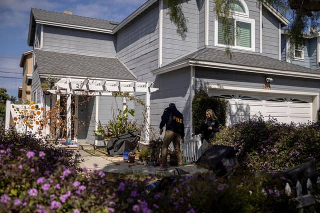 FBI agents at a home in a nice California neighbourhood beside one linked to Trump gun suspect. (Stephen Lam/San Francisco Chronicle via AP)