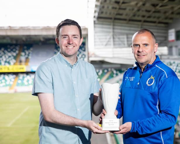 NIFWA Chairman Michael Clarke hands Dungannon Swifts boss Rodney McAree with the Manager of the Month prize for April