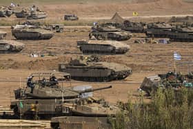 Israeli soldiers gather in a staging area near the border with Gaza Strip, in southern Israel, yesterday. Any military invasion of Gaza will see Israeli soldiers taking on Hamas terrorists who are well embedded in the area in underground tunnels