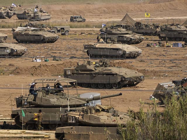 Israeli soldiers gather in a staging area near the border with Gaza Strip, in southern Israel, yesterday. Any military invasion of Gaza will see Israeli soldiers taking on Hamas terrorists who are well embedded in the area in underground tunnels