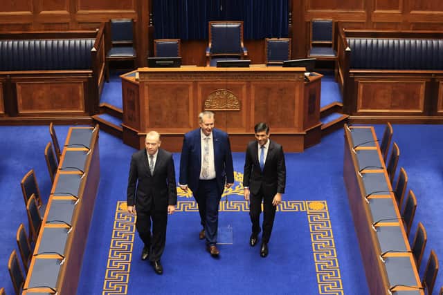 (left to right) Northern Ireland Secretary Chris Heaton-Harris, Speaker of the Northern Ireland Assembly DUP MLA Edwin Poots and Prime Minister Rishi Sunak tour the Assembly Chamber at Parliament Buildings at Stormont
