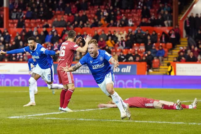 Rangers' Scott Arfield celebrates scoring the winning goal - his second injury-time finish last night in a dramatic 3-2 win over Aberdeen