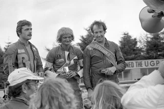 Raymond McCullough wears the winner’s sash after the 350cc race in the Ulster Grand Prix at Dundrod in August 1982. With him are second placed Phil Mellor and Bob McElnea who was third. Picture: News Letter archives/Darryl Armitage