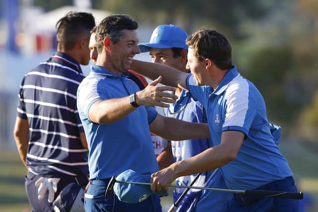 Rory McIlroy and Matt Fitzpatrick celebrate on the 15th green during yesterday's memorable Ryder Cup start by Team Europe. (Photo by Mike Ehrmann/Getty Images)