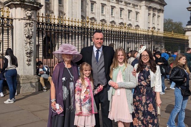 Michael Boyd OBE pictured at Buckingham Palace with mum Jacqueline Granleese, wife Cathy and two daughters Rachel and Olivia