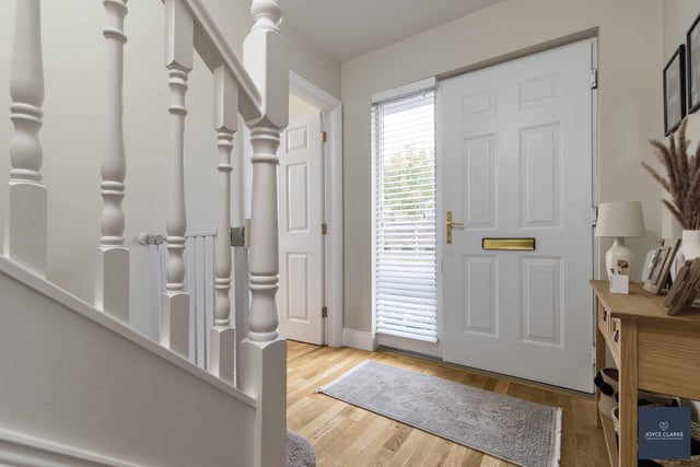 The bright entrance hall has a UPVC door with glazed panel to side, wood effect laminate flooring and a useful storage closet under the stairs.