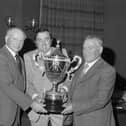 Brian King (centre) gives a hand with the handsome trophy presented to Reggie Suffern (left), Crumlin and Jack Liggett, Tandragee during Ulster Ayrshire Club’s annual dinner and prize distribution which was held in Ballymena in November 1981. Picture: Farming Life archives/Darryl Armitage