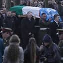 The coffin of Private Sean Rooney is carried into Holy Family Church, Dundalk, Co Louth for his funeral mass.