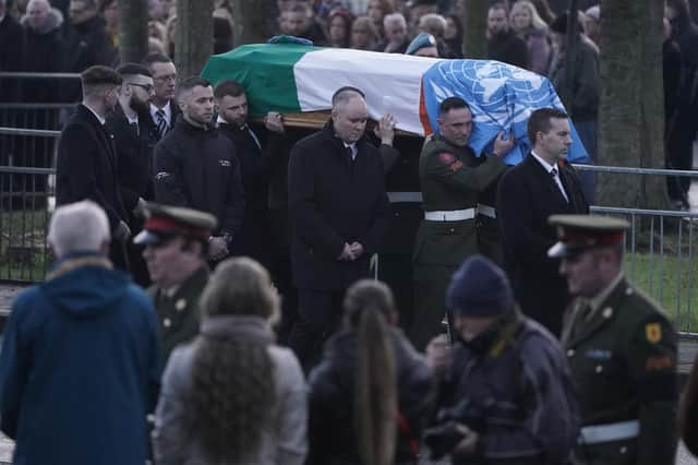 The coffin of Private Sean Rooney is carried into Holy Family Church, Dundalk, Co Louth for his funeral mass.