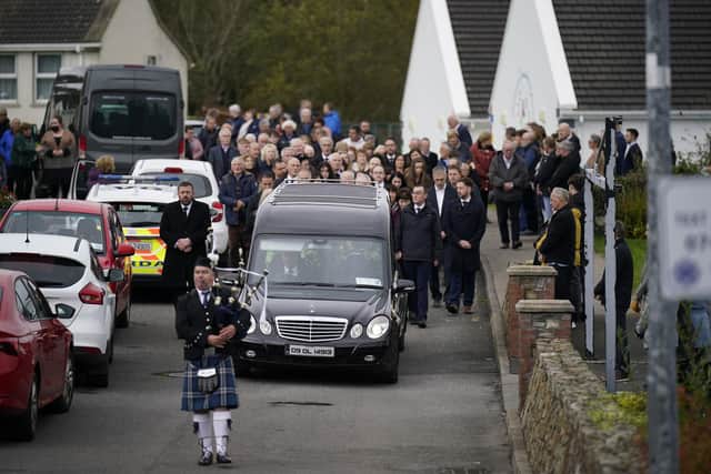 A piper plays as the hearse carrying Martin McGill, 49, arrives at St Michael's Church, Creeslough, for his funeral mass. Martin died following an explosion at Applegreen service station in the village of Creeslough in Co Donegal on Friday. Picture date: Tuesday October 11, 2022. PA Photo. See PA story IRISH Donegal. Photo credit should read: Niall Carson/PA Wire 