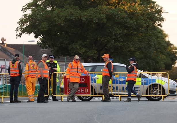 Manx police and race marshals at the scene of the fatal accident on Tuesday at the Southern 100 on the Isle of Man.