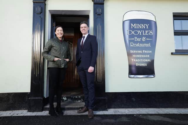Husband and wife duo Michael and Aveen Moreland have taken over ownership of Minny Doyle’s, the popular traditional Irish pub in Hilltown once owned by Aveen’s family, as part of a six-figure investment. Pi ctured is Ulster Bank business development manager Lee White with new owner of Minny Doyle’s pub in Hilltown, Aveen Moreland