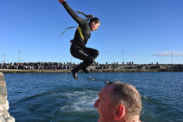 Leaping into 2024 at the annual New Year's Day swim in Carnlough, Co. Antrim, Northern Ireland.