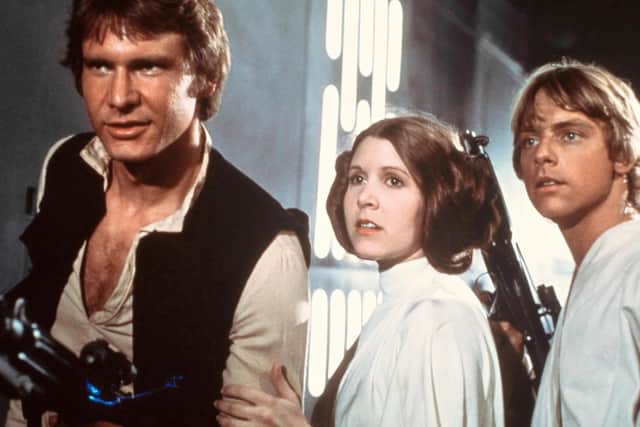 Harrison Ford, Carrie Fisher and Mark Hamill in Star Wars: A New Hope (1977) directed by George Lucas. Today, May the 4th, is unoffically known as Star Wars Day since the phrase is so similar to the phrase 'May the force be with you' which is recurrent across the hugely popular sci-fi franchise