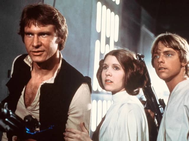 Harrison Ford, Carrie Fisher and Mark Hamill in Star Wars: A New Hope (1977) directed by George Lucas. Today, May the 4th, is unoffically known as Star Wars Day since the phrase is so similar to the phrase 'May the force be with you' which is recurrent across the hugely popular sci-fi franchise