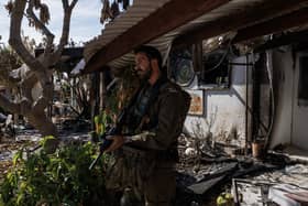Israeli soldiers yesterday patrolling Kibbutz Nir Oz, southern Israel, which was overran by Hamas terrorists on October 7, killing or capturing a quarter of its community. The terrorist attack will be remembered as Israel's 9/11, writes Nigel Mooney