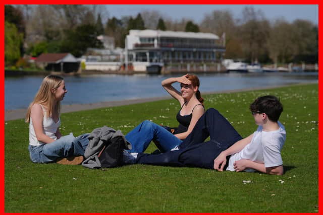 (left to right) Florence Hulcup, Jessica Kemp, and Tom Spann enjoy the good weather beside the River Thames in Henley-on-Thames