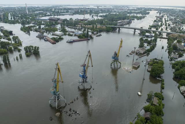 Streets and trade port are seen underwater and polluted by oil in the flooded Kherson, Ukraine. The destruction of the Kakhovka Dam in southern Ukraine is swiftly evolving into long-term environmental catastrophe. It affects drinking water, food supplies and ecosystems reaching into the Black Sea. (AP Photo)