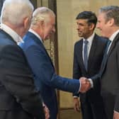 King Charles III speaks with Prime Minister Rishi Sunak and Labour leader Sir Keir Starmer  during his visit to Westminster Hall at the Palace of Westminster to attend a reception ahead of the coronation.