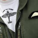 A Spitfire aircraft logo is displayed on the flight suit of an airman from the RAF during a display at RAF Coningsby in Lincolnshire, central England (photo credit should read PAUL ELLIS/AFP via Getty Images)
