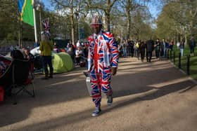 A royal fan walks along The Mall yesterday ahead of today's royal coronation in London. The ceremony will show how the world has progressed. The coronation will unite all four parts of the United Kingdom (Photo by Carl Court/Getty Images)