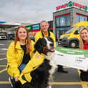 Caitlin McCartney, Ken Humphrey and Harvey the dog from SOS Bus NI are pictured with Bronagh Luke from Spar NI at Henderson Group receiving their Community Cashback Grant last year. Applications for the 2024 Grant are open until May 22, and this year will see 20 organisations receive £1,000 each