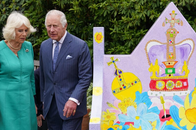 King Charles III and Queen Camilla view a bench at Hillsborough Castle, Co Down, which was designed by pupils from Belfast's Blythefield Primary School, who have taken part in Historic Royal Palaces' competition to design Coronation benches