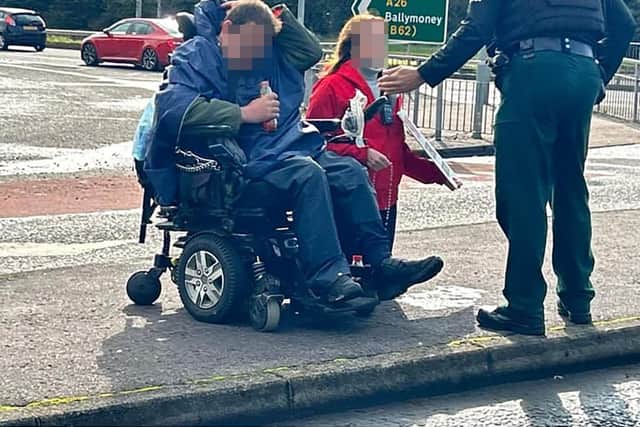 The PSNI arrested a man and a woman in relation to abortion clinic Safe Access Zones at Causeway Hospital on Tuesday. A friend of the woman says she is a devout Catholic and can be seen kneeling in prayer with her rosary beads while an officer speaks to her.