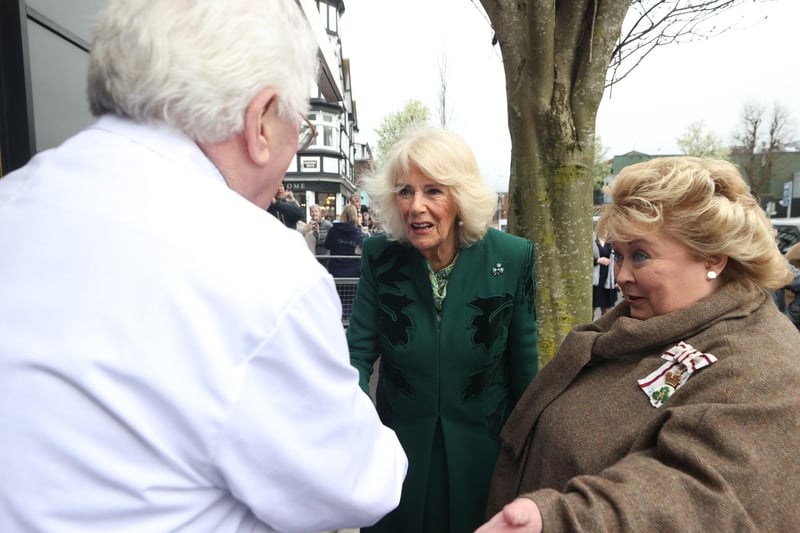 Queen Camilla (centre) with Lord-Lieutenant Dame Fionnuala Jay-O'Boyle (right) during a visit to Lisburn Road in Belfast to meet shop owners and staff, and learn about their positive contribution to the community during her two-day official visit to Northern Ireland.