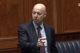 Jon Burrows (pictured speaking in the Assembly today) was a police officer for 22 years, and held command positions in the force
