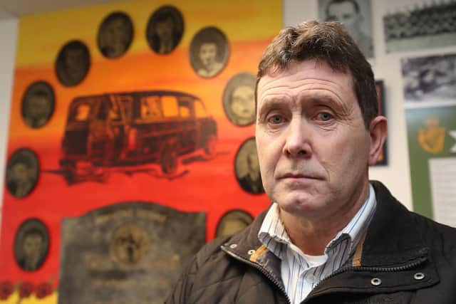 Colin Worton, whose brother Kenneth was one of 10 workmen shot dead by the IRA at Kingsmills. In the background are photos of all ten men and the minibus they were driving.