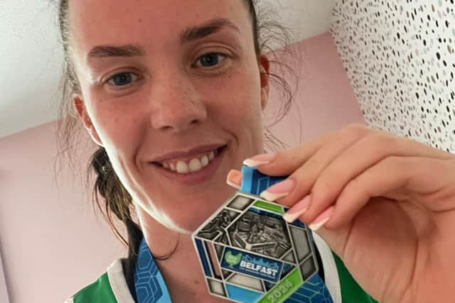 Finisher's medal: Bushmills woman Laura Harpur said she was 'ecstatic' after completing a relay in the Belfast Marathon. A cancer survivor, she helped organise 20 runners to raise money for Macmillan Cancer.