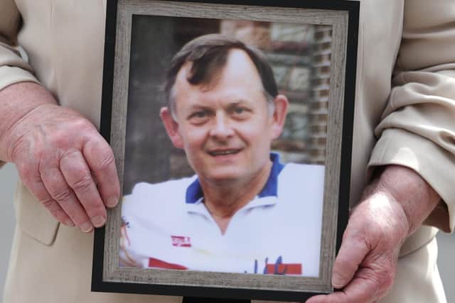 Bridie Brown, the widow of murdered GAA official Sean Brown, holds a picture of him, outside the Royal Courts of Justice in Belfast last year. Pic: Liam McBurney/PA Wire