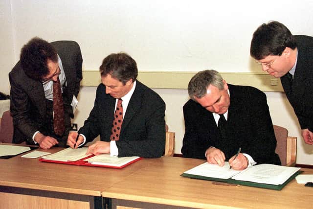 Former Prime Minister, Tony Blair (Left) and Irish Taoiseach Bertie Ahern signing The Northern Ireland Peace Agreement