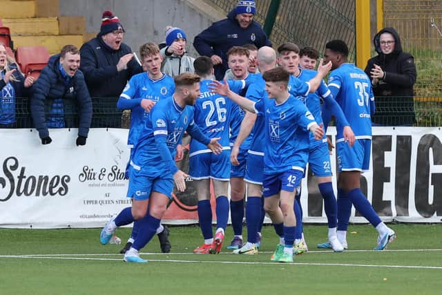 Dungannon Swifts players and fans celebrate after Joe Moore's late winner against Cliftonville at Solitude.