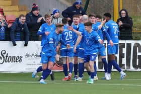 Dungannon Swifts players and fans celebrate after Joe Moore's late winner against Cliftonville at Solitude.