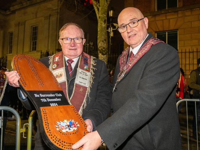 Drew McIntyre from the No Surrender Club is presented with the commemorative shoe  by Governor William Walker before the burning of the effigy of Lundy.