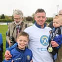 Limavady United Paul Owens celebrates with his family after lifting the Premier Intermediate League title. Picture: NIFL